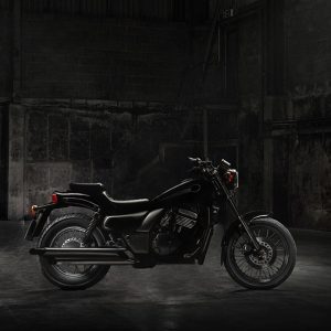 MTC-004_vintage-motorcycle-standing-dark-building-rays-sunlight-side-view