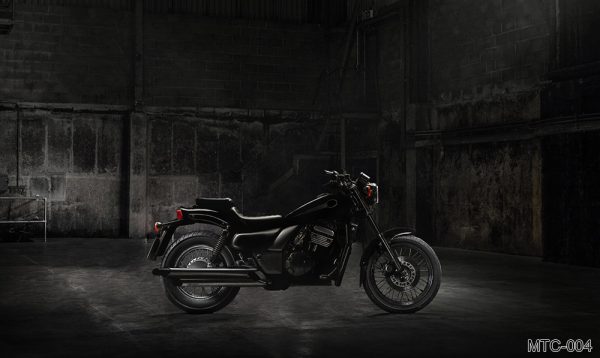 MTC-004_vintage-motorcycle-standing-dark-building-rays-sunlight-side-view