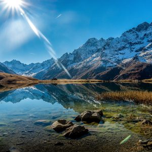 RIV-007_beautiful-shot-crystal-clear-lake-snowy-mountain-base-during-sunny-day